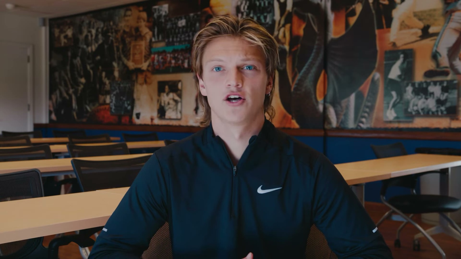 A student telling his story at a table