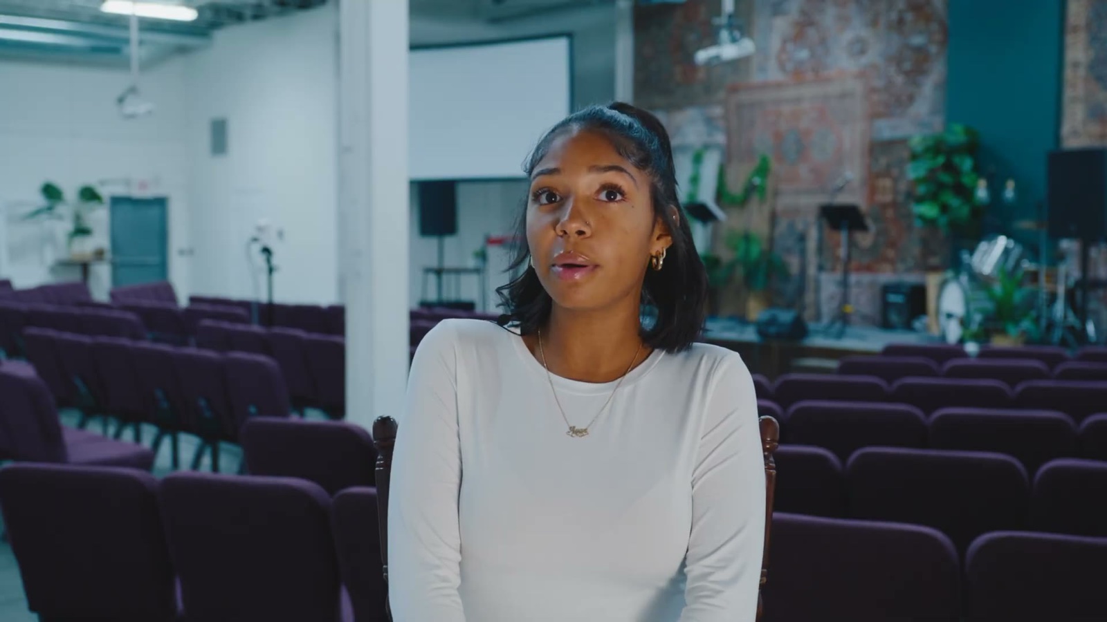 A student telling her story in an open meeting space