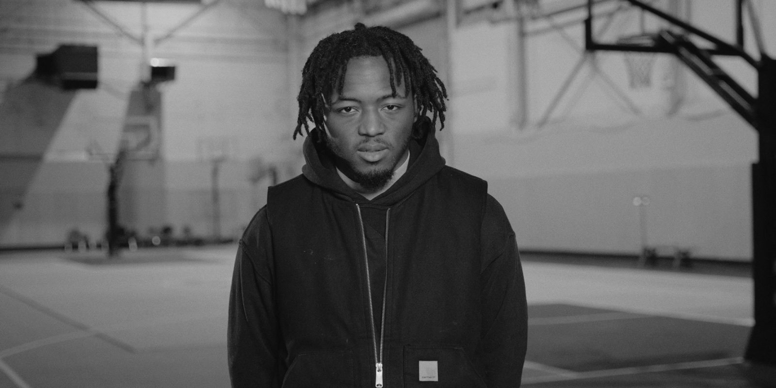 A student standing in the gym during his interview