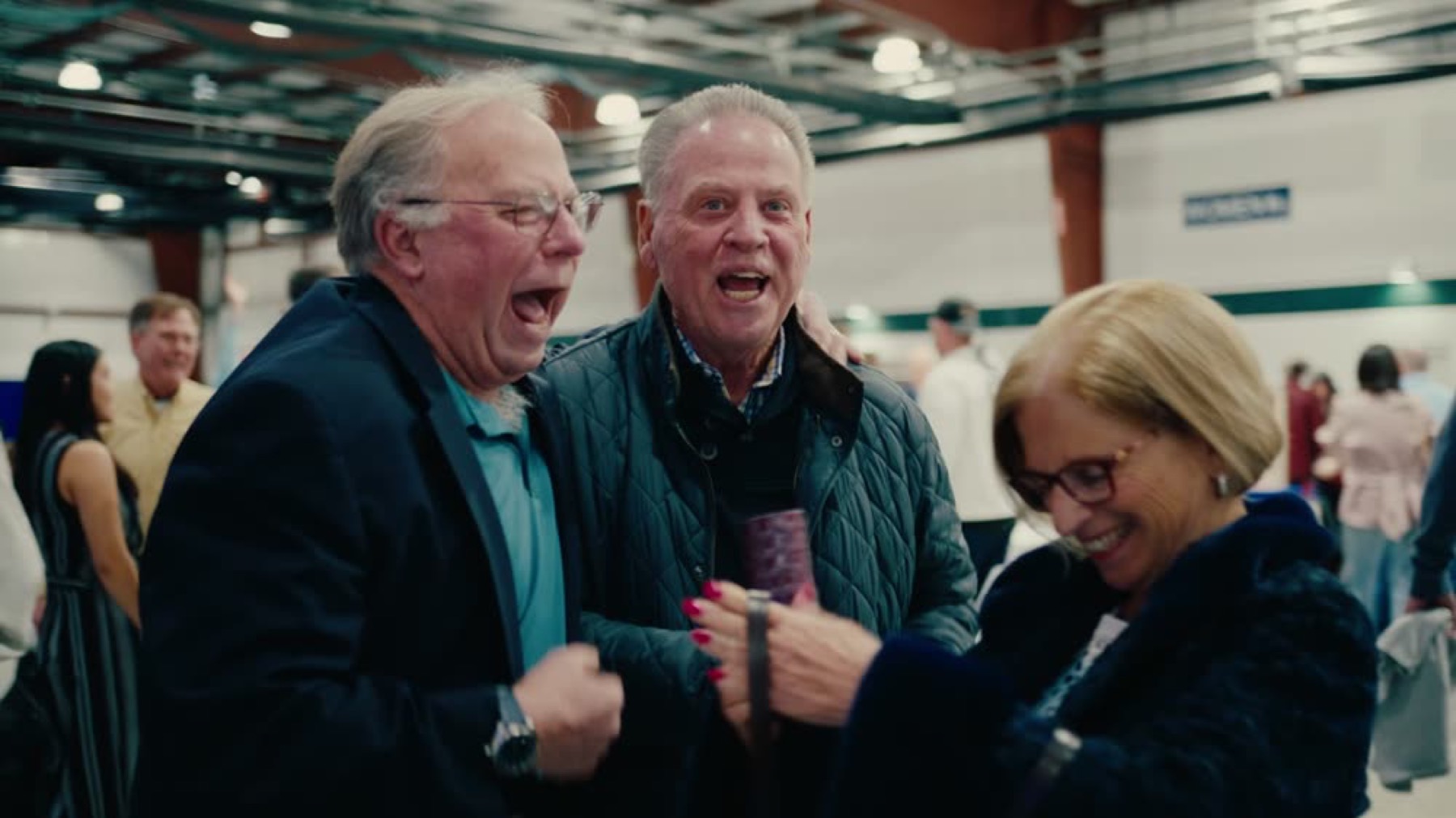 Longtime supporters laughing together at the Bob Huggins Fish Fry
